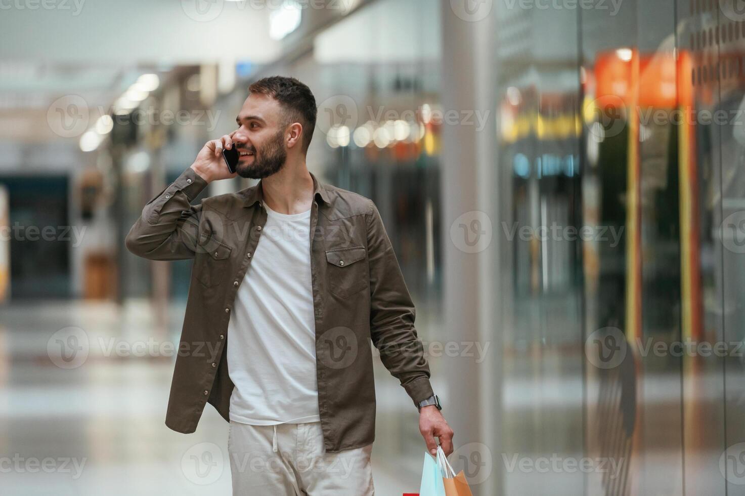 Talking by phone. Man is shopping in the supermarket., photo