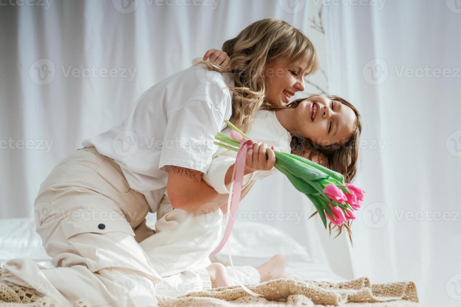Embracing ,each other. Celebrating mother's day. With flowers. Parent with daughter at home photo