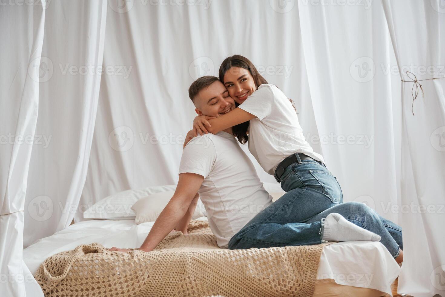 In casual clothes, embracing each other. Young couple are together at home photo