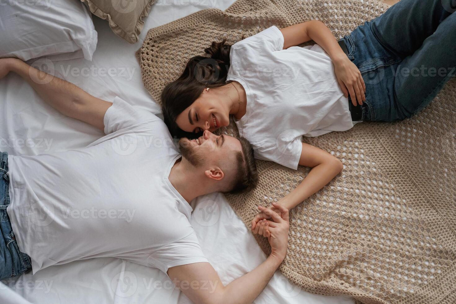 Top view, lying down,. Young couple are together at home photo