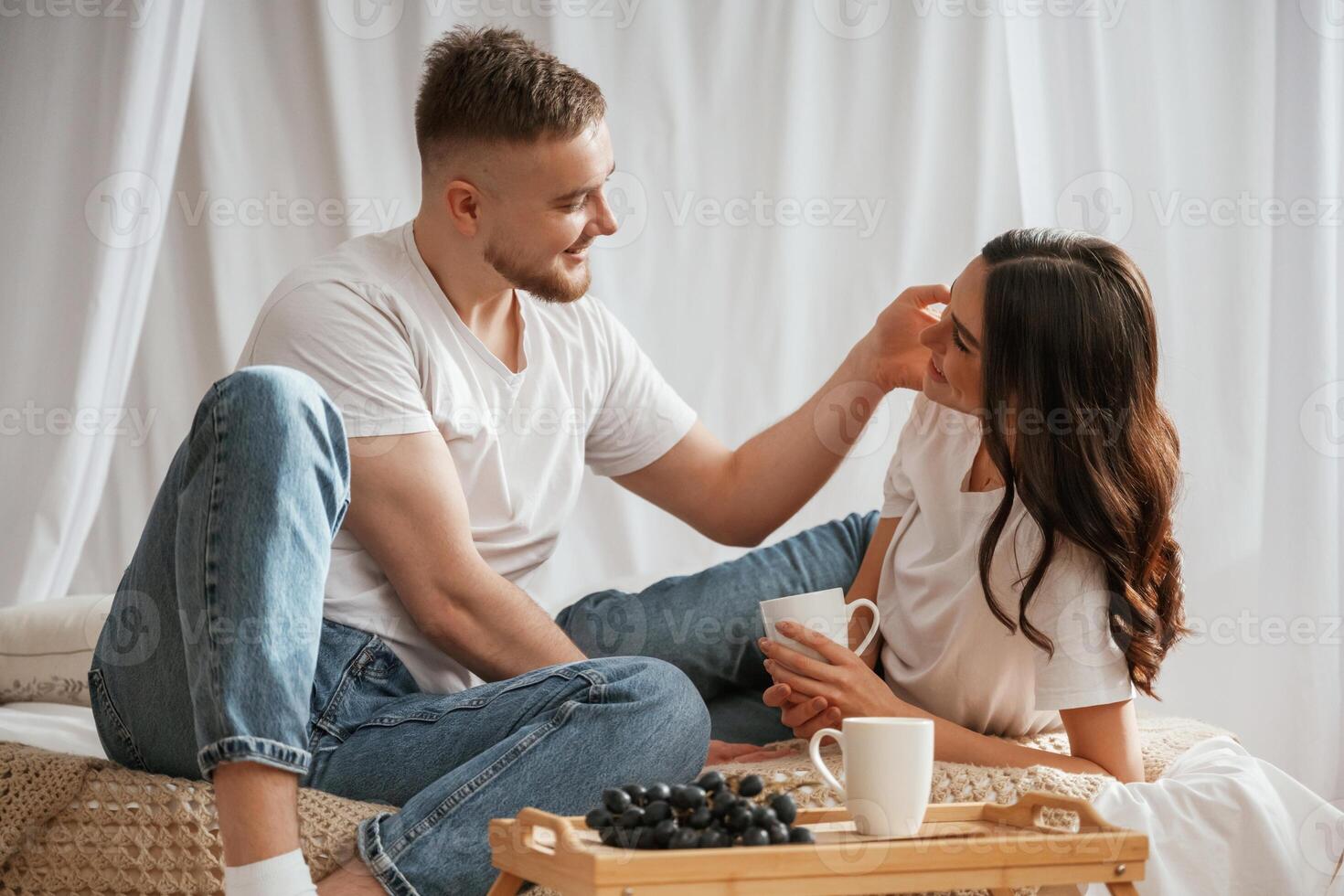 Grape, and cups of drink. Young,, couple are together at home photo