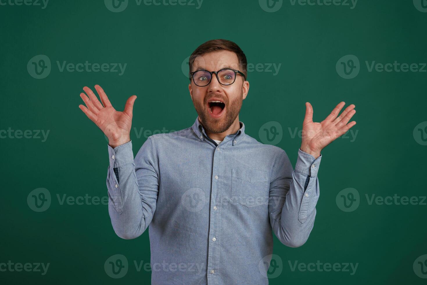 Shocked facial expression. Man is standing against background in the studio photo