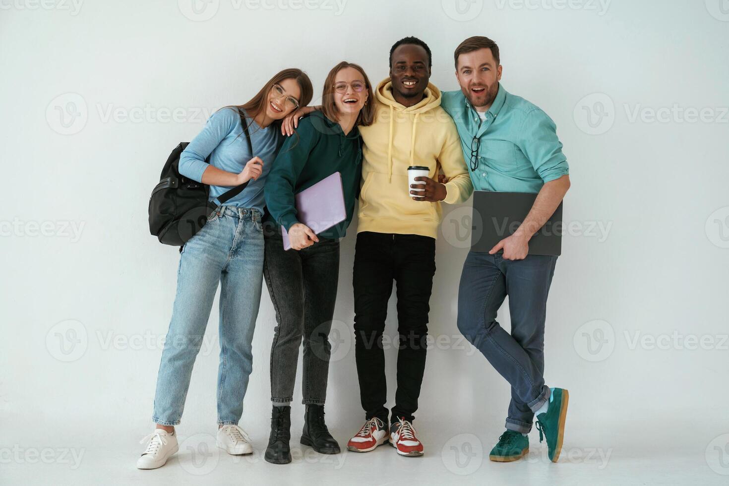 Looking forward. Group of, young people are standing against white background photo