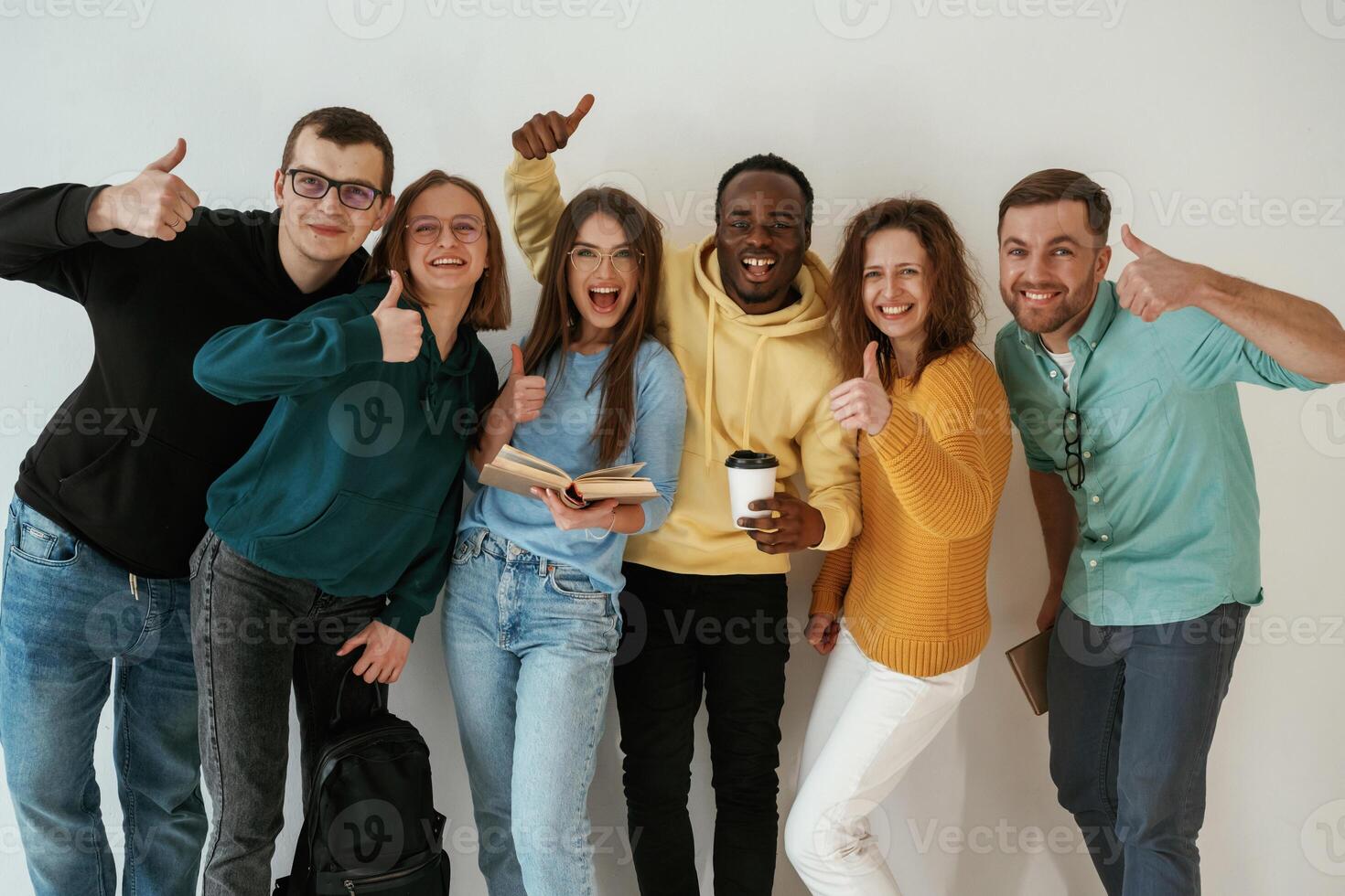 Standing, against white, background. Group of young people are together photo
