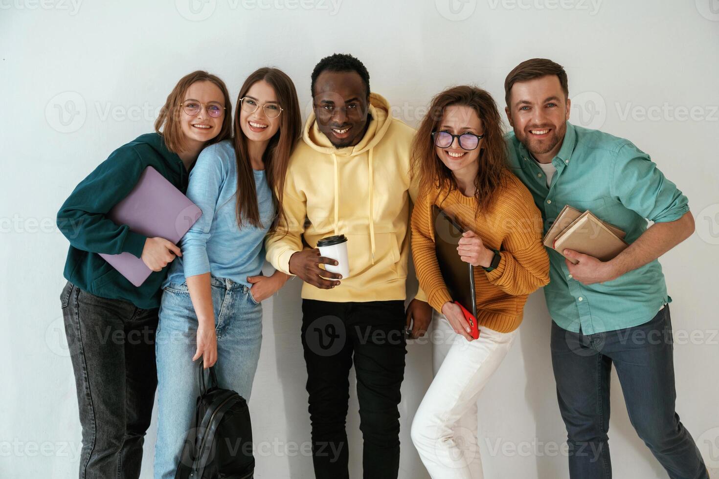 Positive ,friends.. Group of young people are standing against white background photo