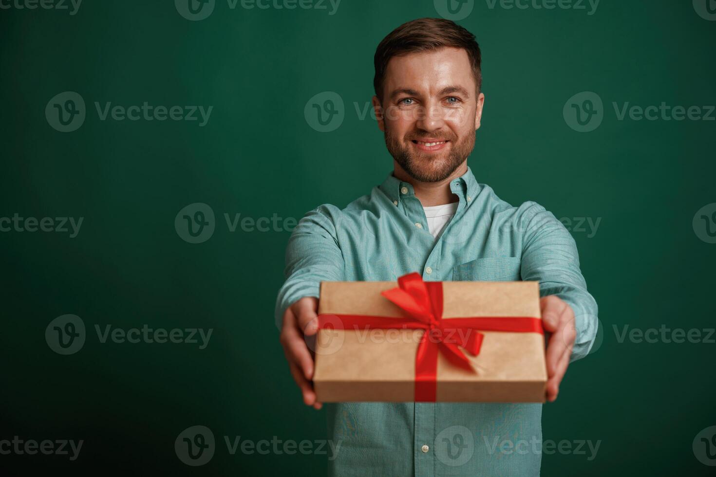 Conception, of ,holidays, with gift box. Man is standing against background in the studio photo