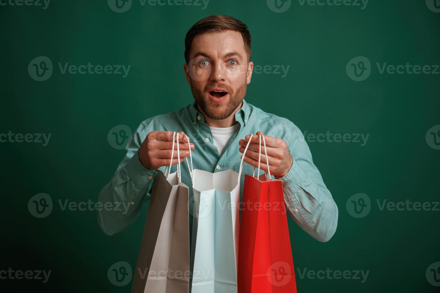 Shocked, facial expression. Man is standing against background in the studio photo