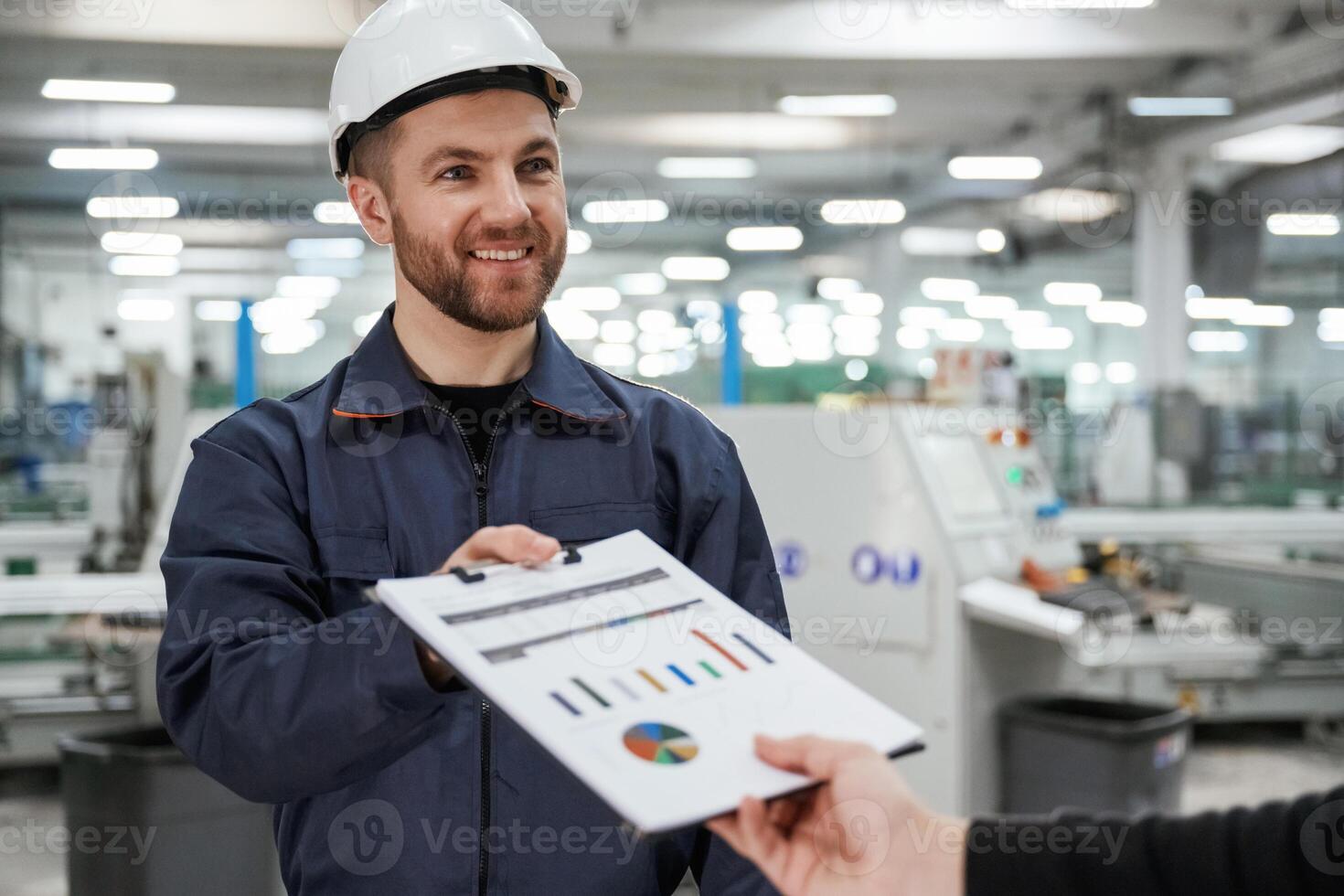 Giving the document, with ,,plan. Man on the factory is making deal with other person photo