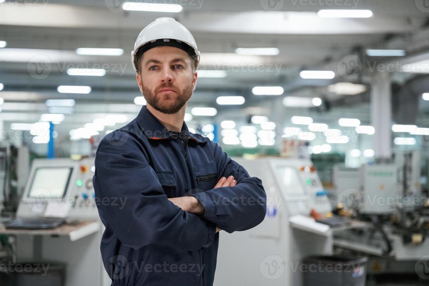 Posing, with, arms, crossed., Factory worker is indoors with hard hat photo