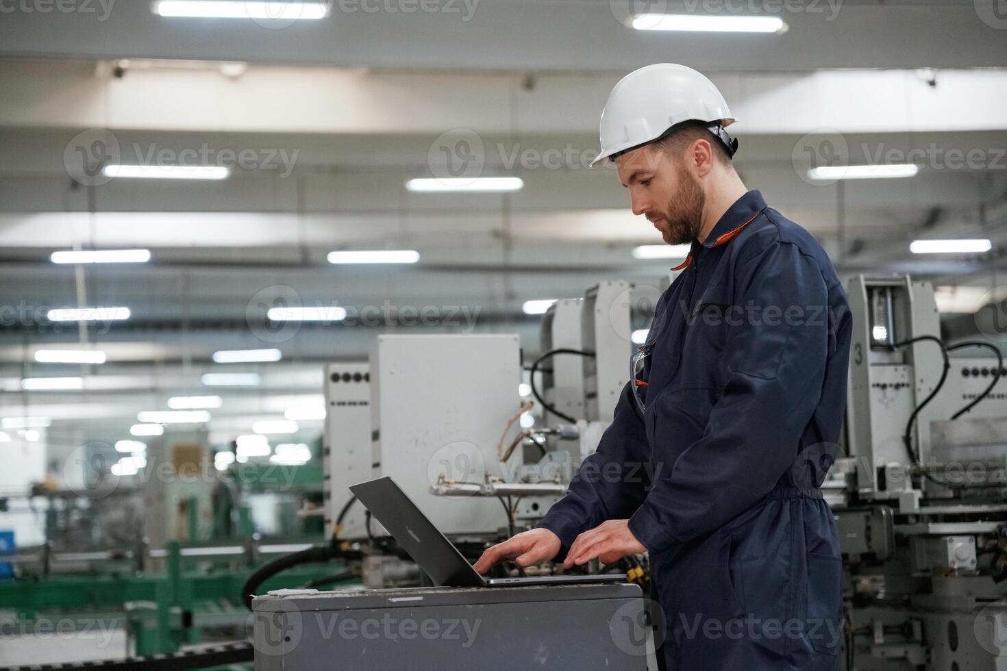 Busy, employee. Factory ,,worker is indoors with hard hat photo