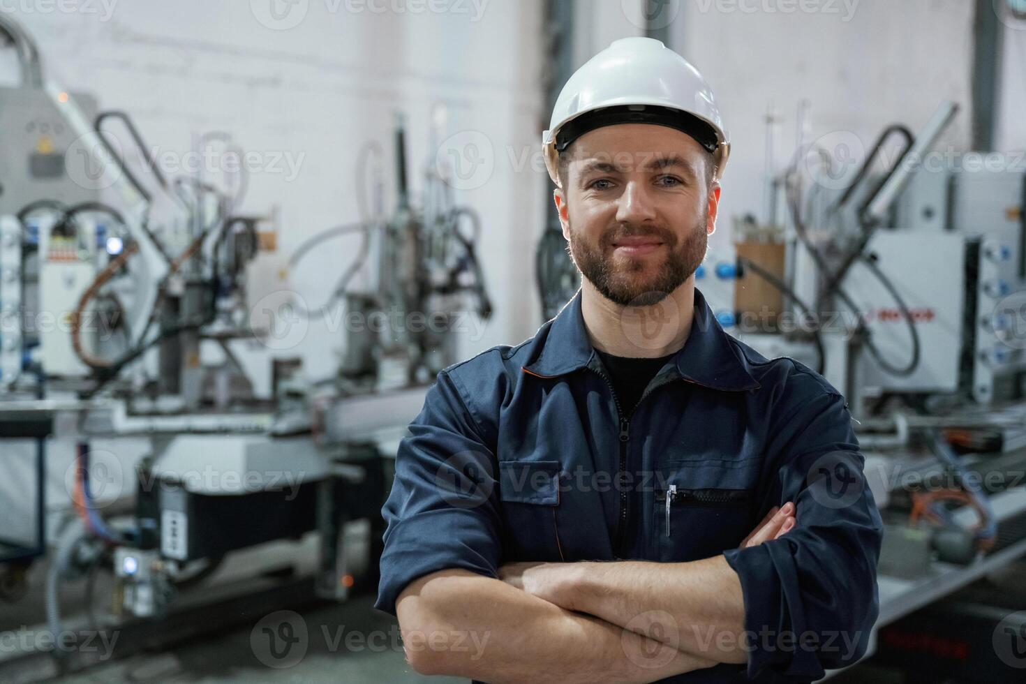 Front view. Factory worker ,is ,,indoors with hard hat photo