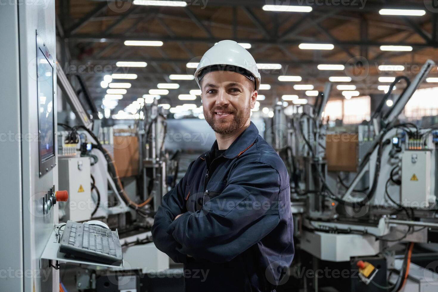 Using, equipment, operator. Factory, worker is indoors with hard hat photo