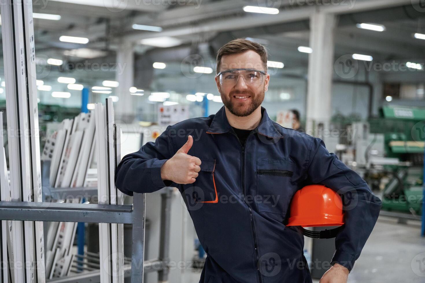 Break,, time, standing. Factory worker is indoors with hard hat photo