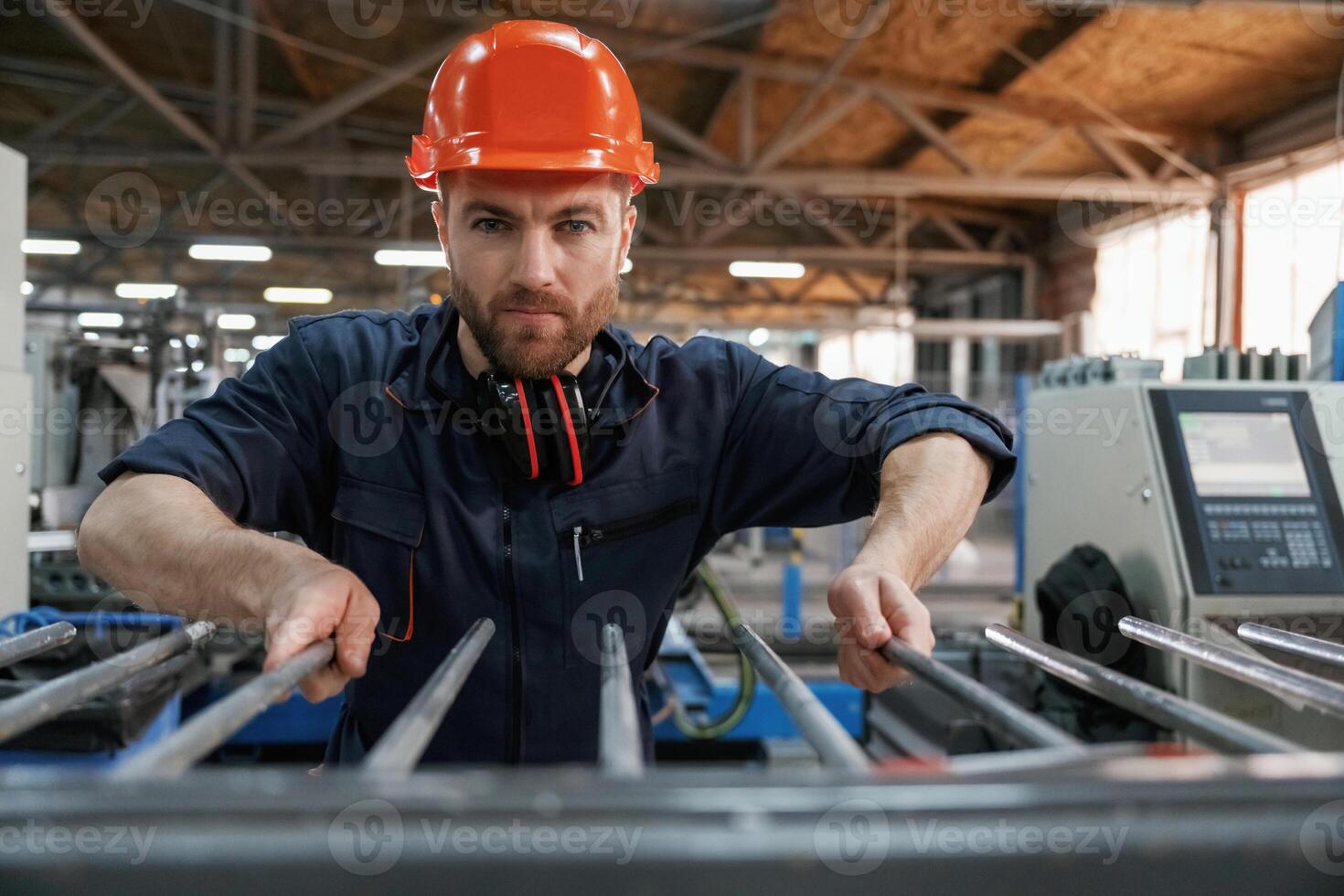 Industrial ,line, working. Factory ,worker is indoors with hard hat photo