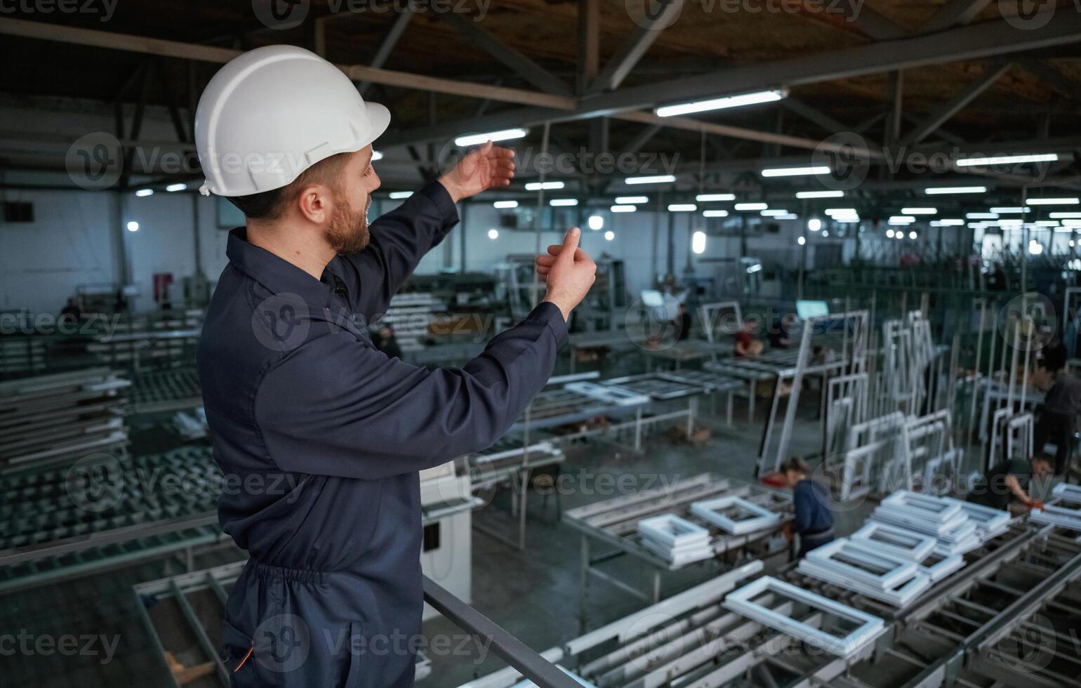 Quality control... Factory worker is indoors with hard hat photo