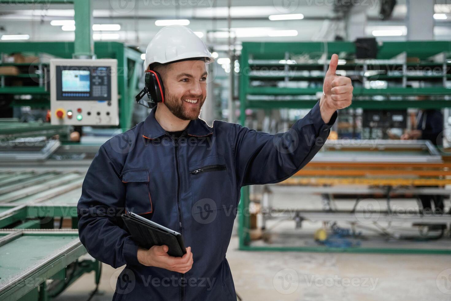 Giving, orders by hand. Factory, worker ,,is indoors with hard hat photo