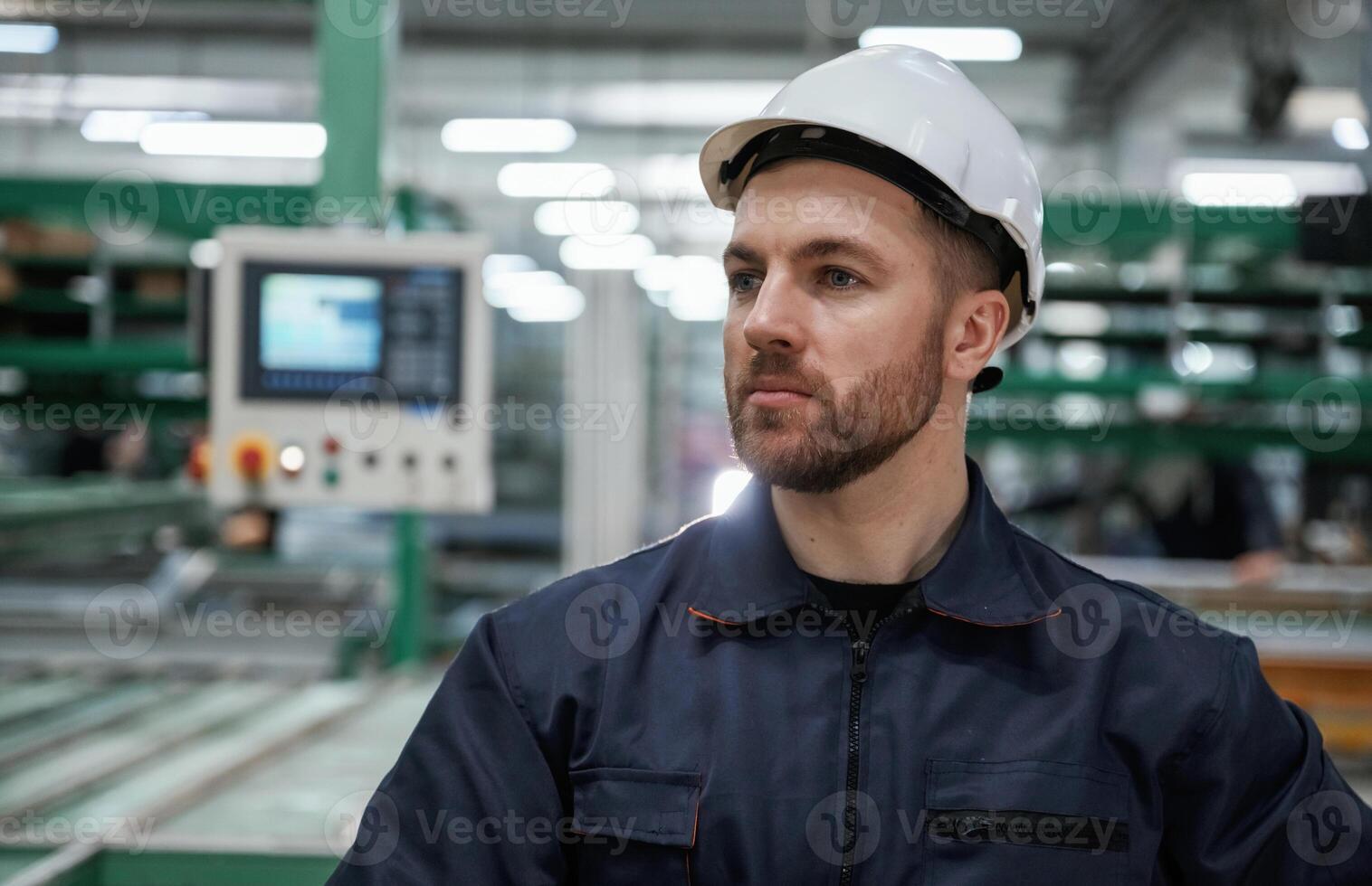 In, white hard hat. Factory worker is indoors photo