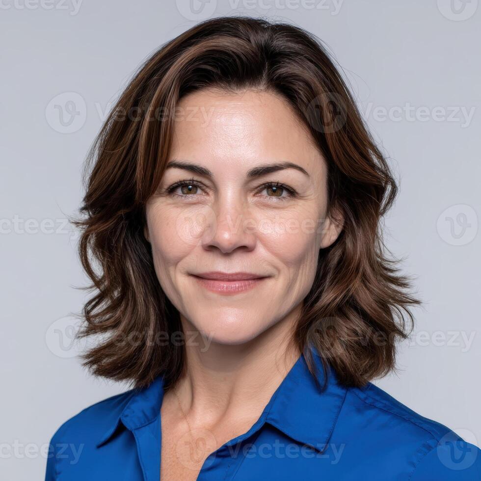 Portrait of a smiling middle aged woman in a blue shirt photo