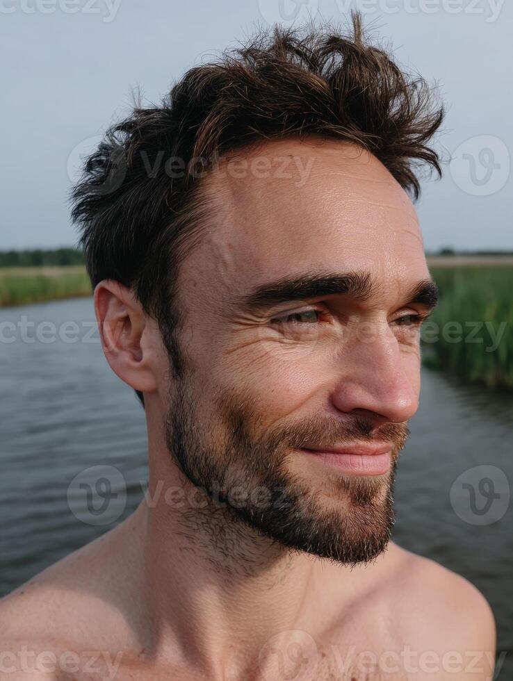 Man with beard standing in water outdoors photo