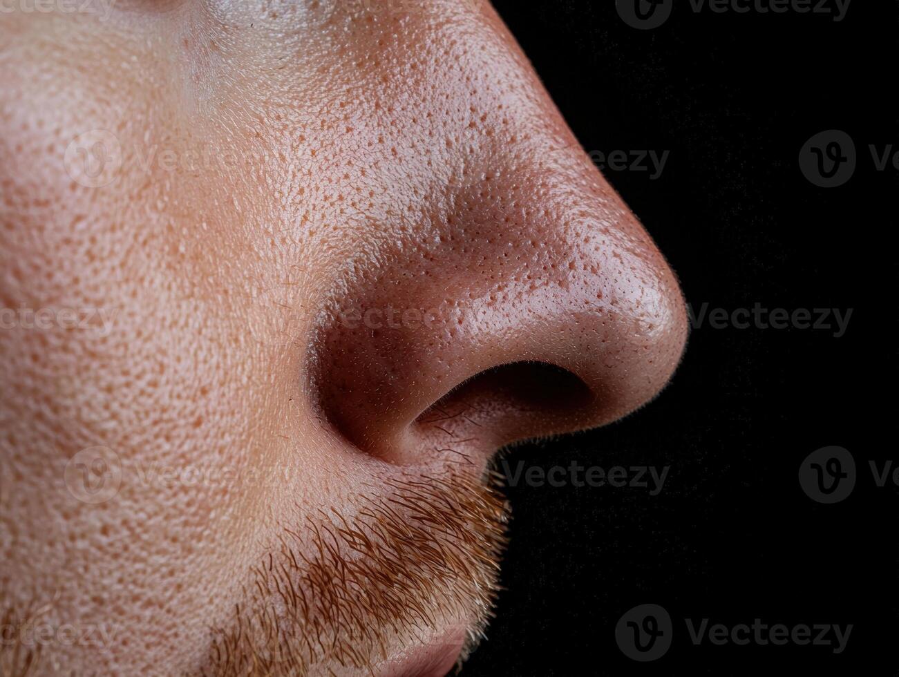 Close up of a mans nose showing pores and facial hair photo