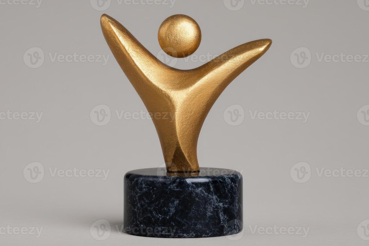 Golden abstract figure on a dark marble base photo