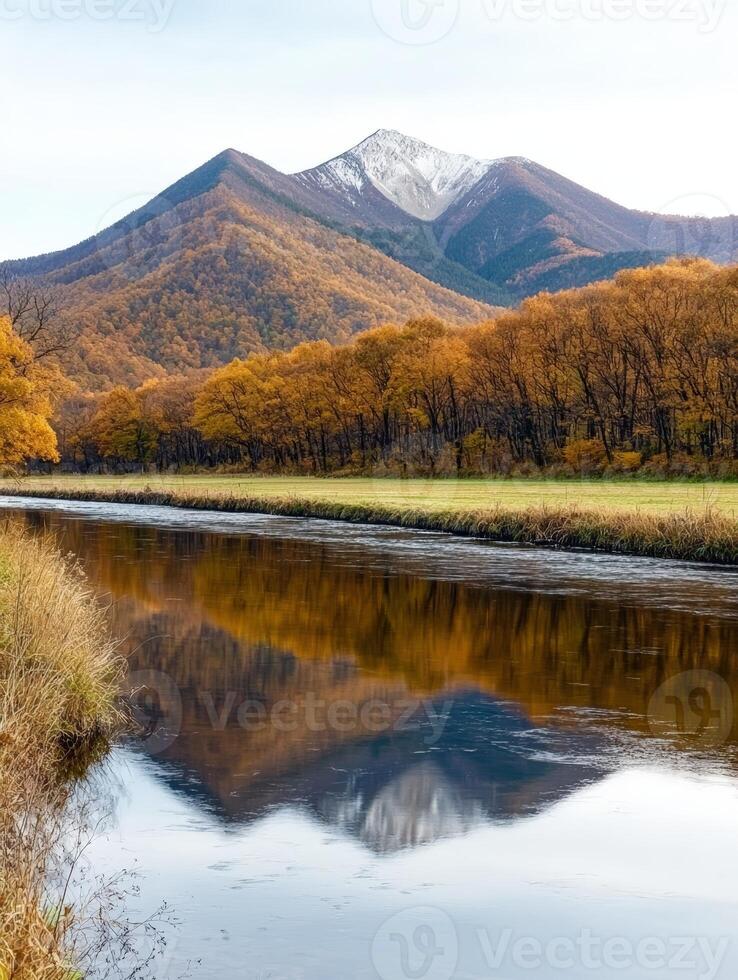 Scenic autumn landscape with mountain reflecting in river photo