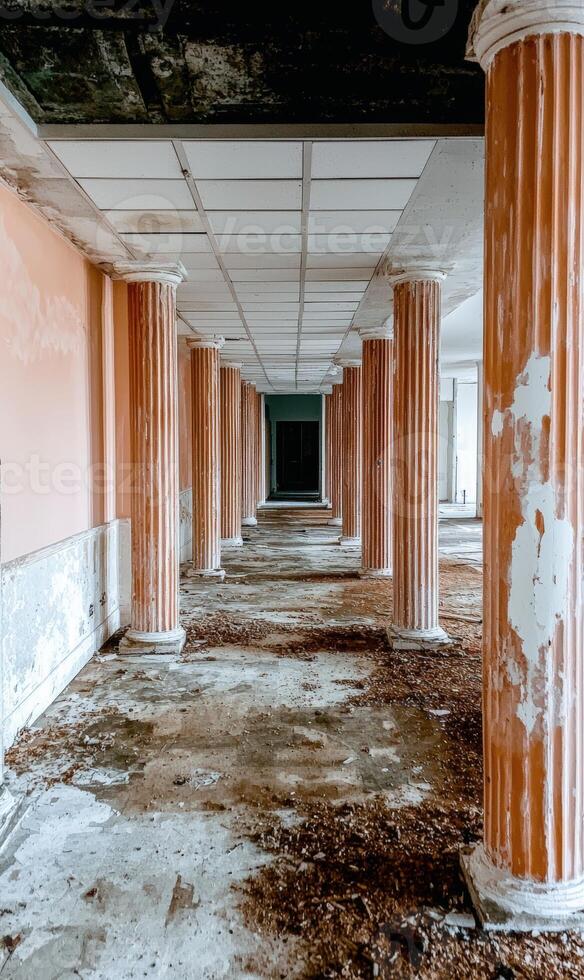 Abandoned hallway with columns in a derelict building photo