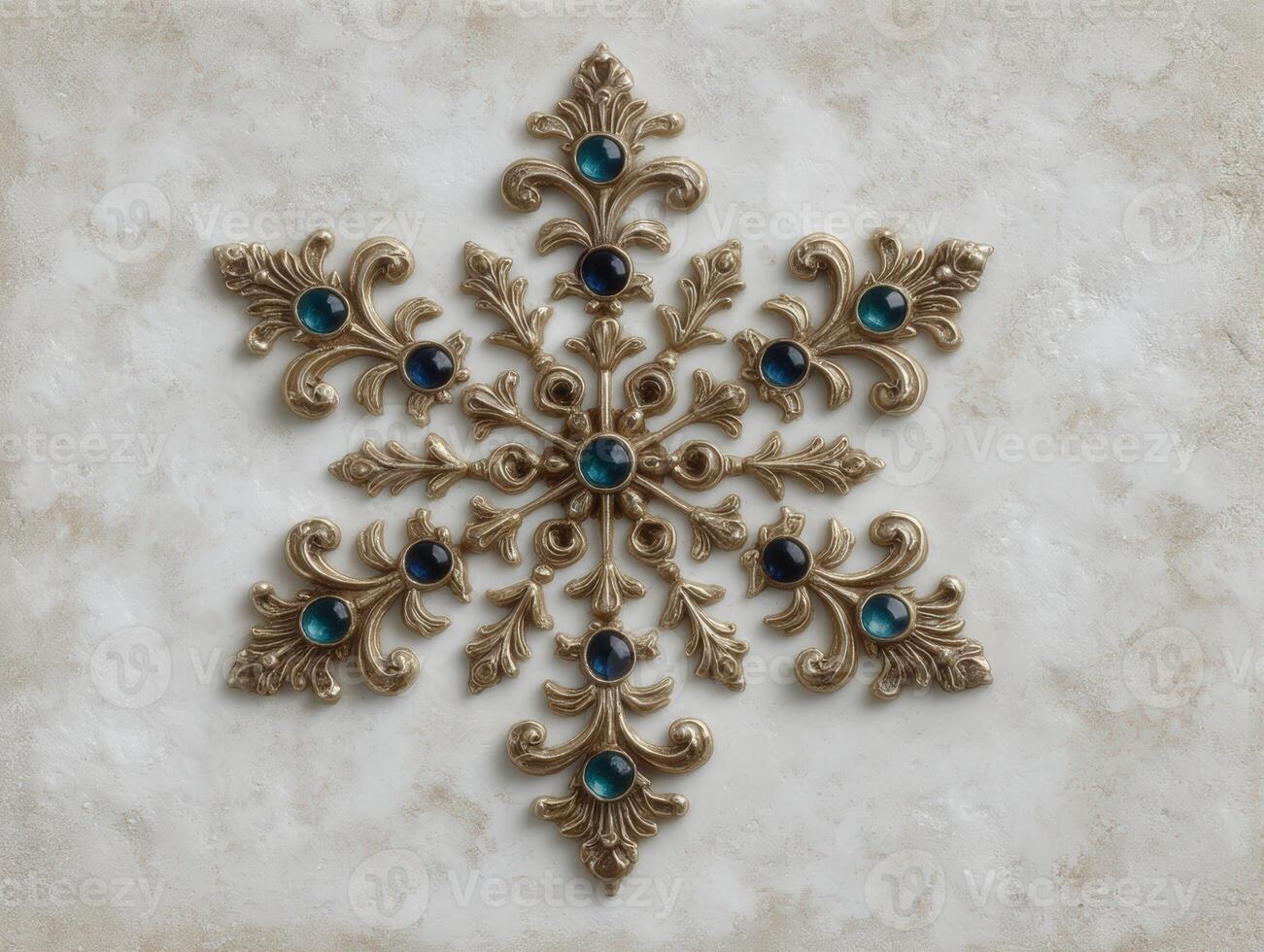 Elegant golden snowflake with blue gems on a textured background photo