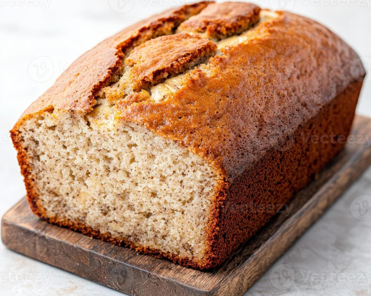 Delicious homemade banana bread loaf on wooden board photo