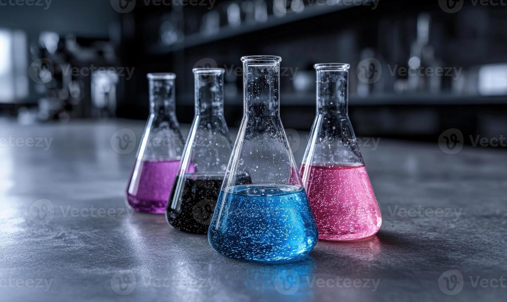 Colorful liquids in laboratory glassware on a counter. photo
