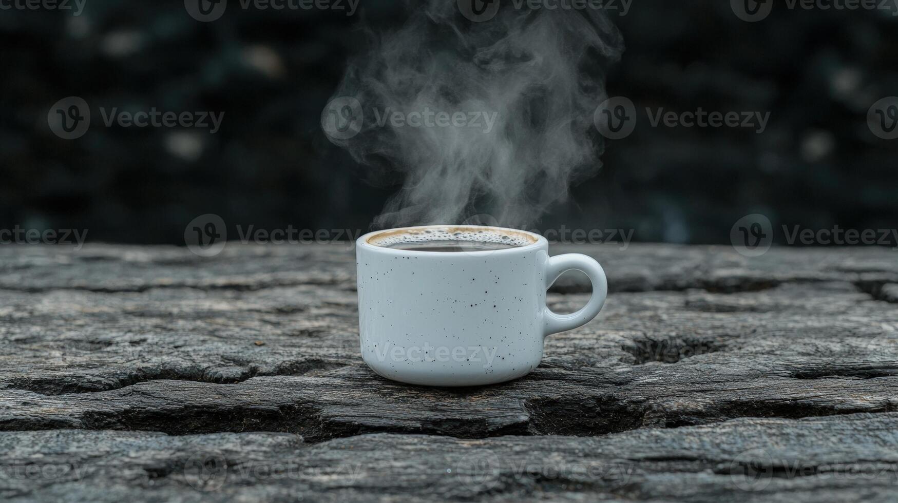 Steaming coffee in a speckled mug on rustic wood photo