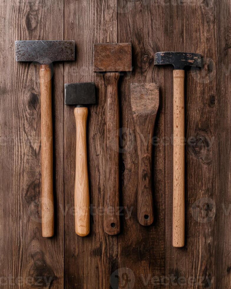 Vintage mallets and tools on rustic wooden surface photo