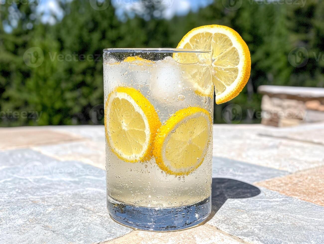 Refreshing lemonade with lemon slices on a sunny day photo