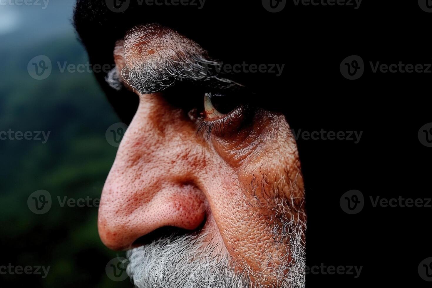 Intense portrait of an elderly man with weathered skin photo