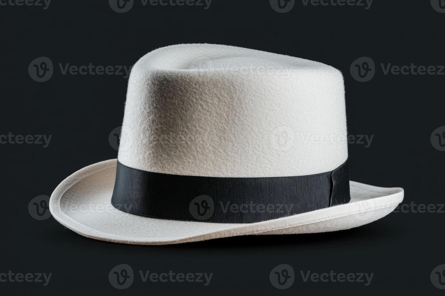 Elegant white fedora hat with black band on dark backdrop photo