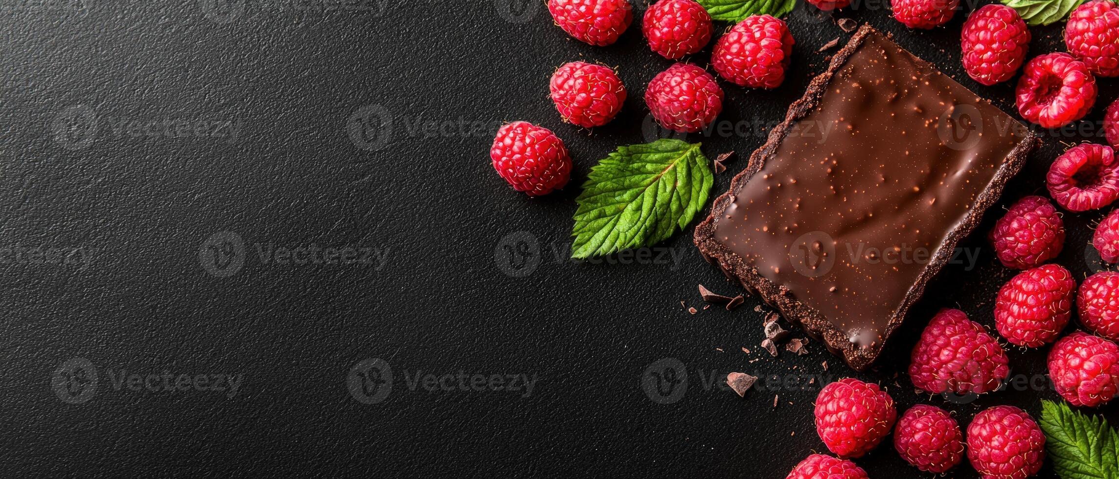 Decadent chocolate tart with fresh raspberries and mint photo