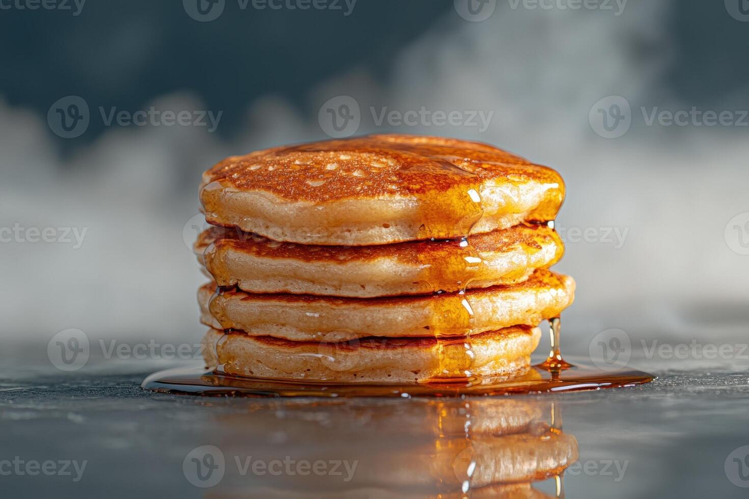 Stack of golden pancakes drizzled with maple syrup photo