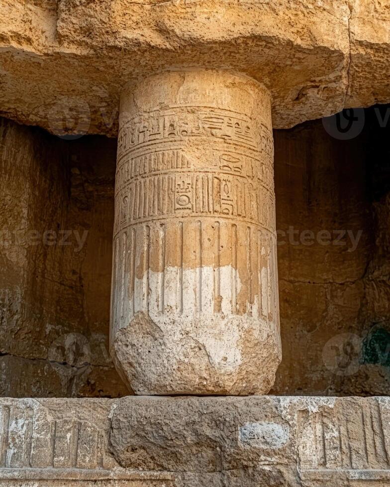Ancient Egyptian column with hieroglyphs in a temple photo