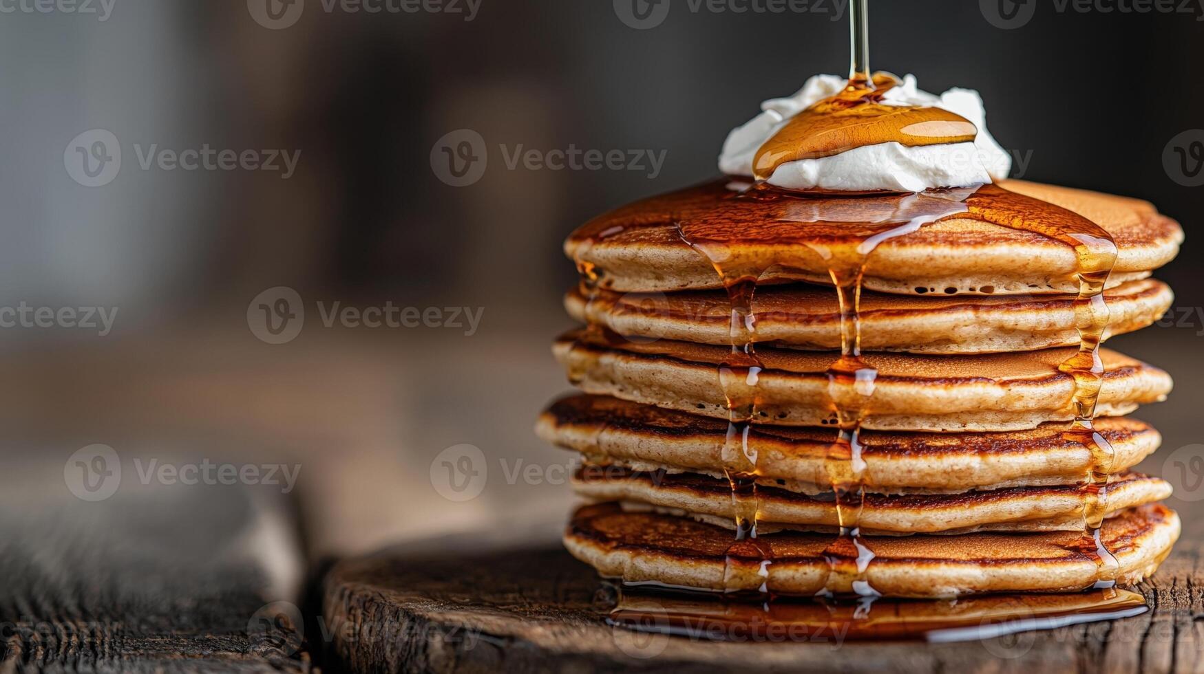 Stack of delicious pancakes with syrup and whipped cream photo