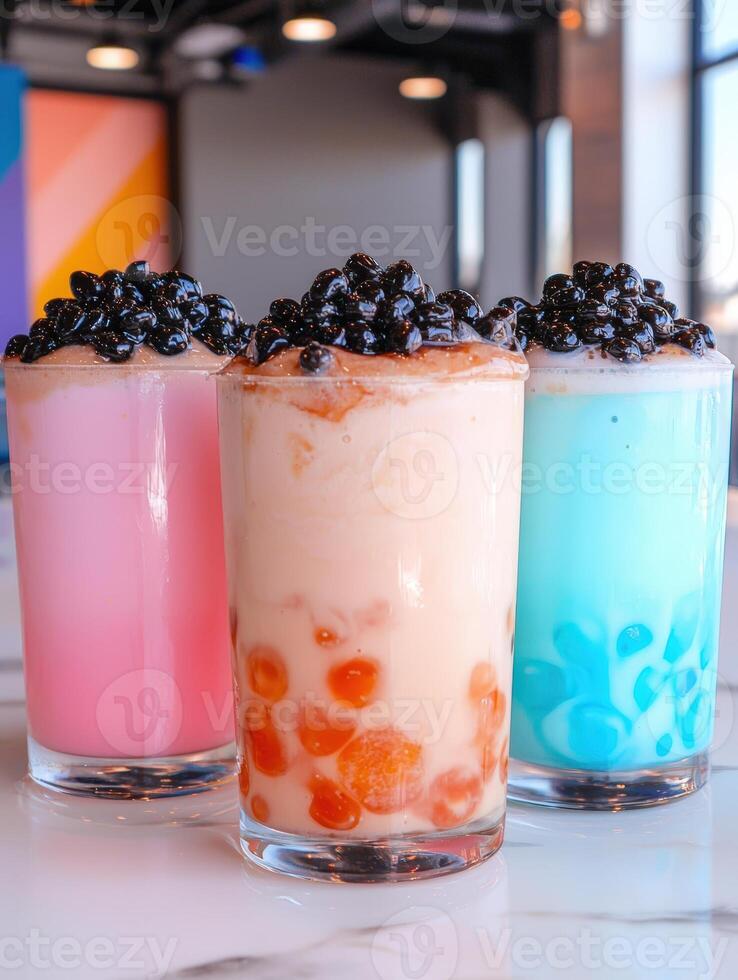 Colorful bubble tea drinks with tapioca pearls on marble photo