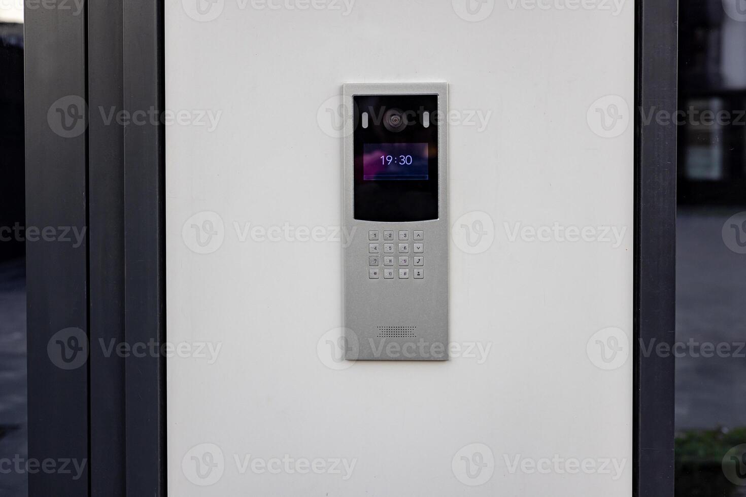 Doorbell with camera and microphone, on the white wall of an apartment building, doorbell camera. photo