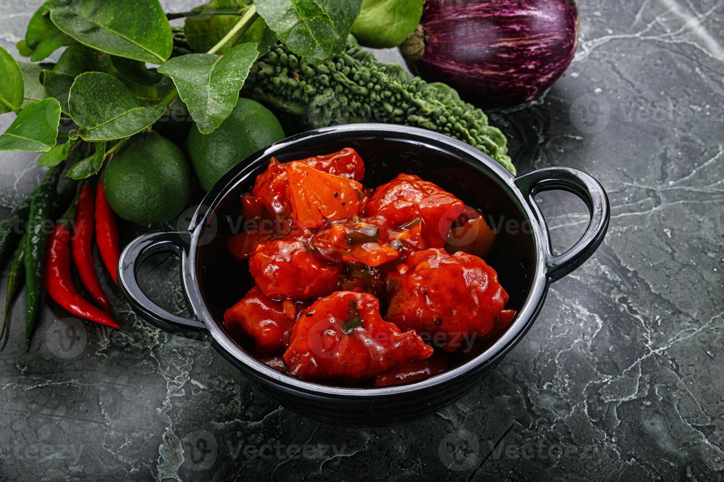 A bowl of food with tomatoes, peppers, and other vegetables photo