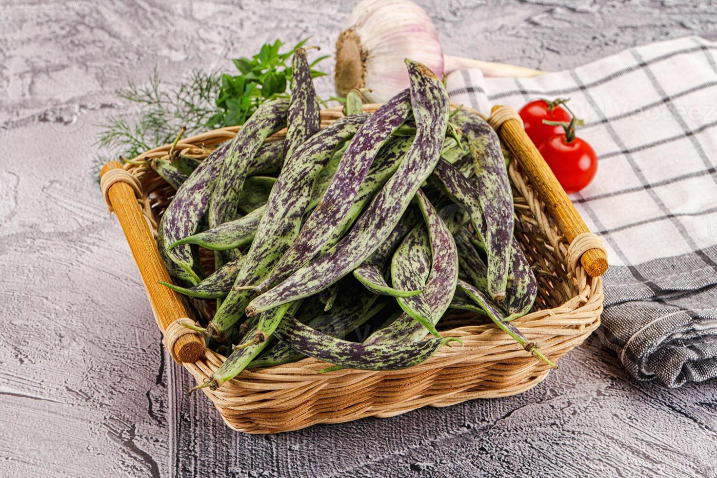A basket filled with green beans and tomatoes photo