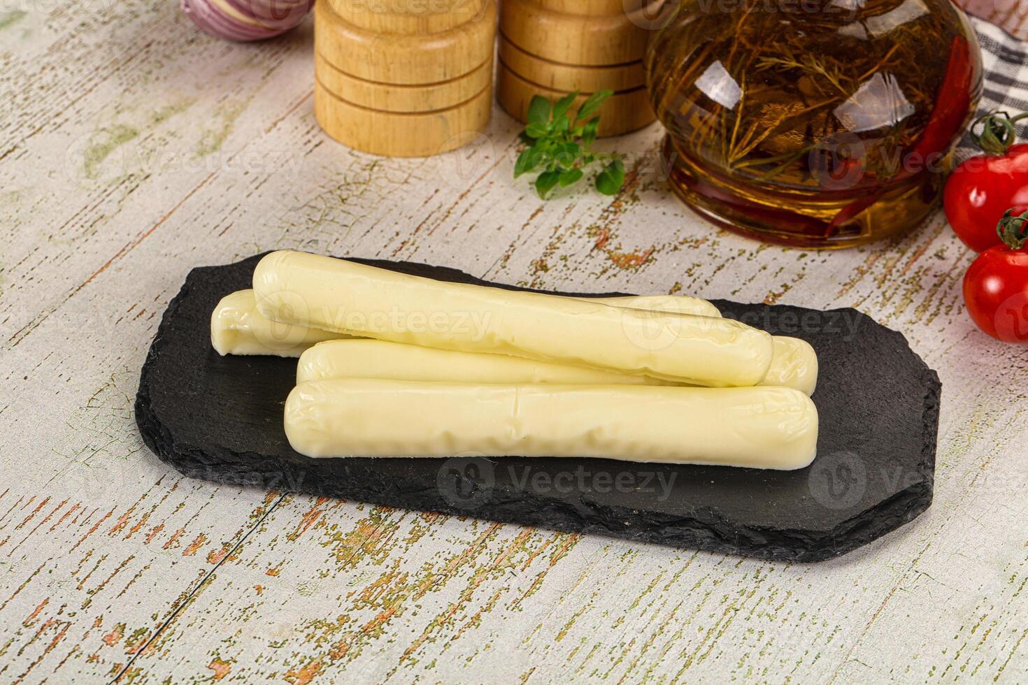 A plate with cheese sticks on it and a bottle of wine photo