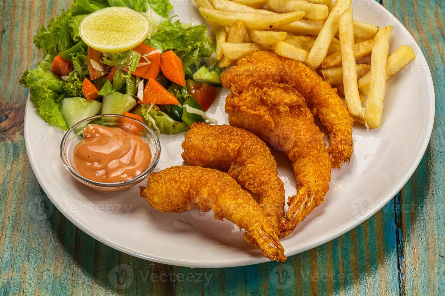 A plate with fried shrimp and french fries photo
