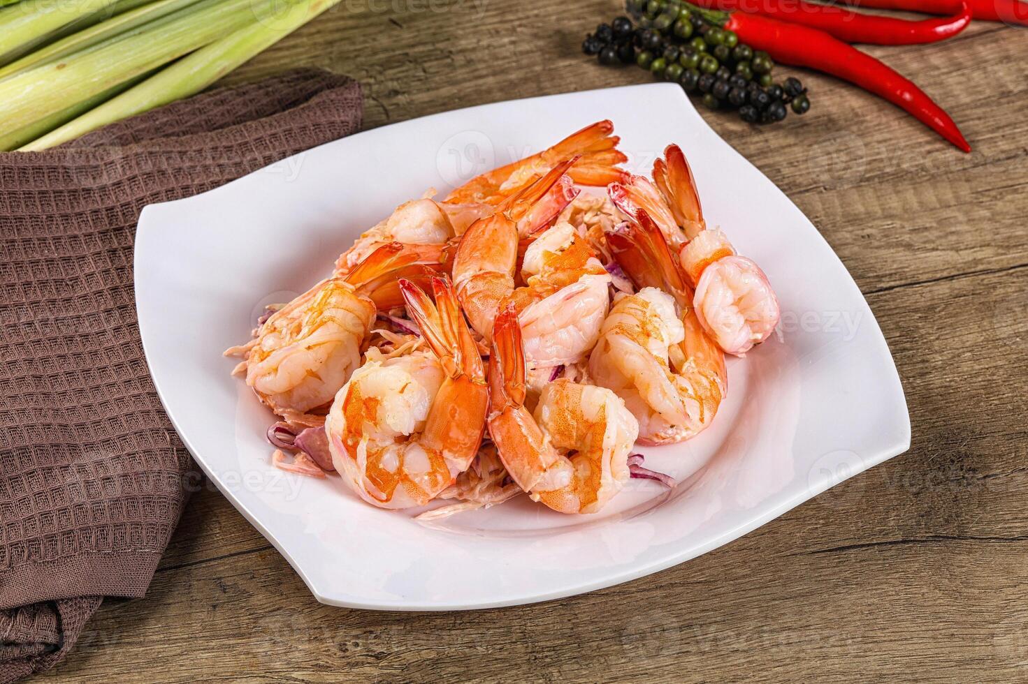 A white plate with shrimp and peppers on it photo