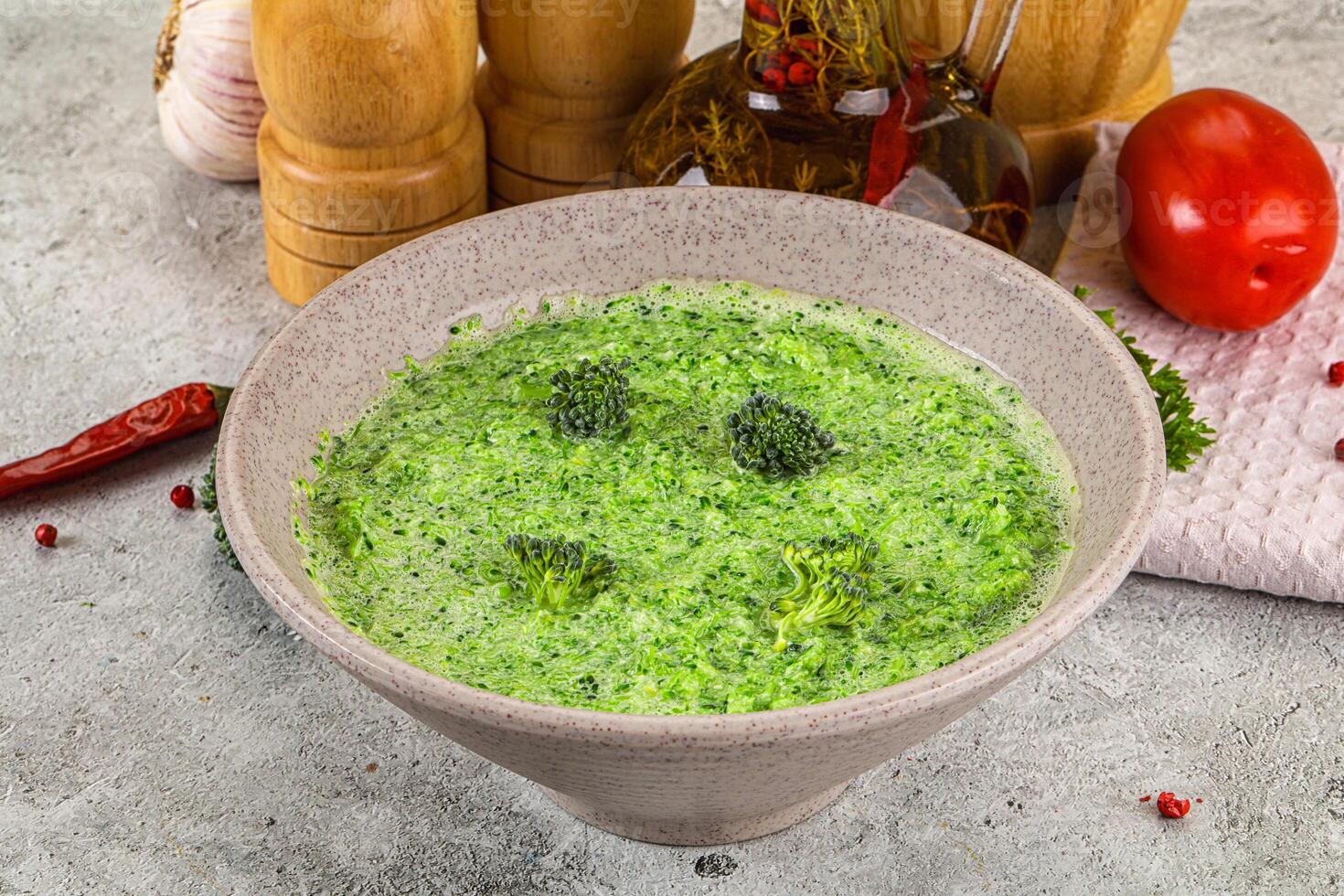 A bowl of soup with broccoli in it photo