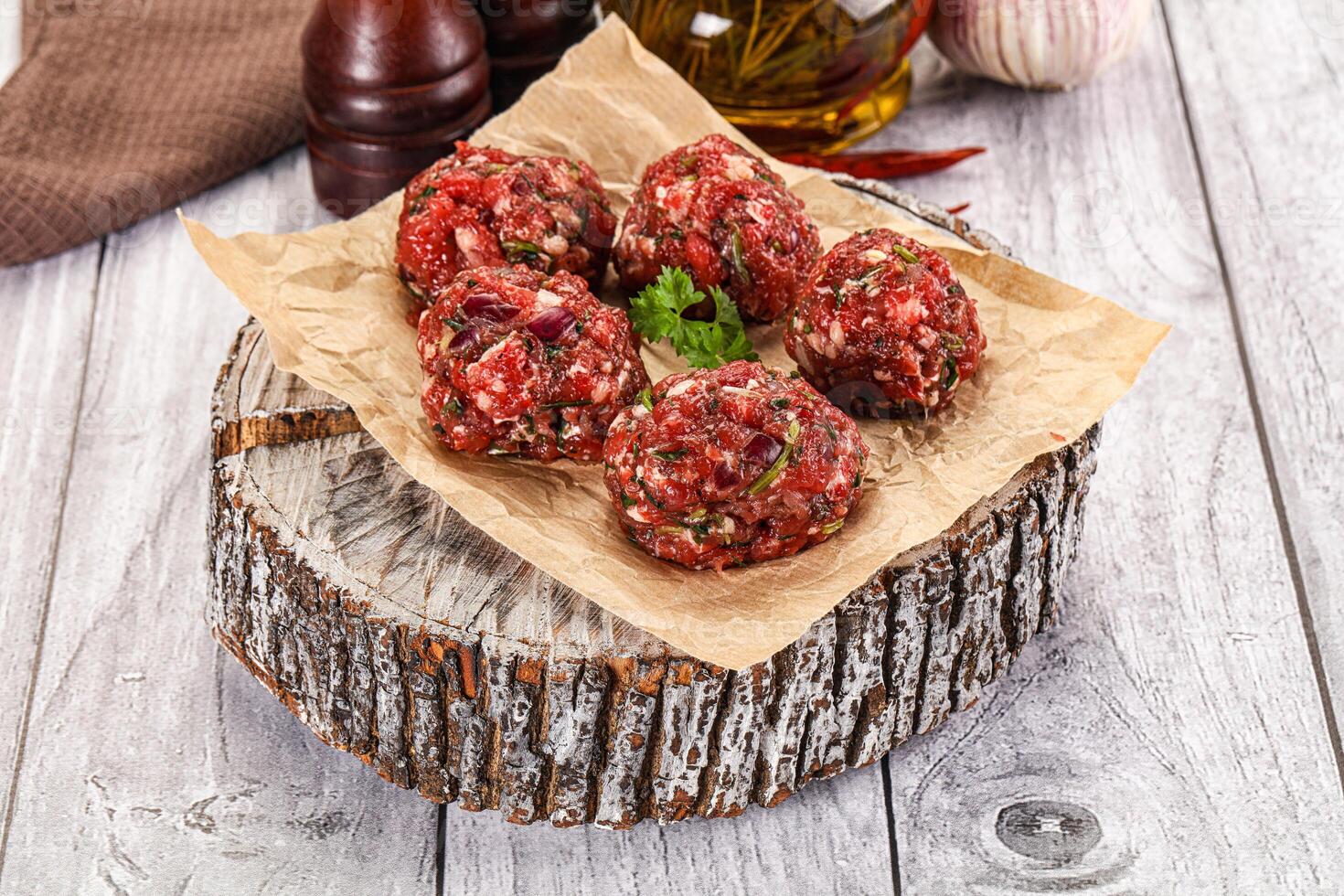A plate of meatballs on a wooden table photo