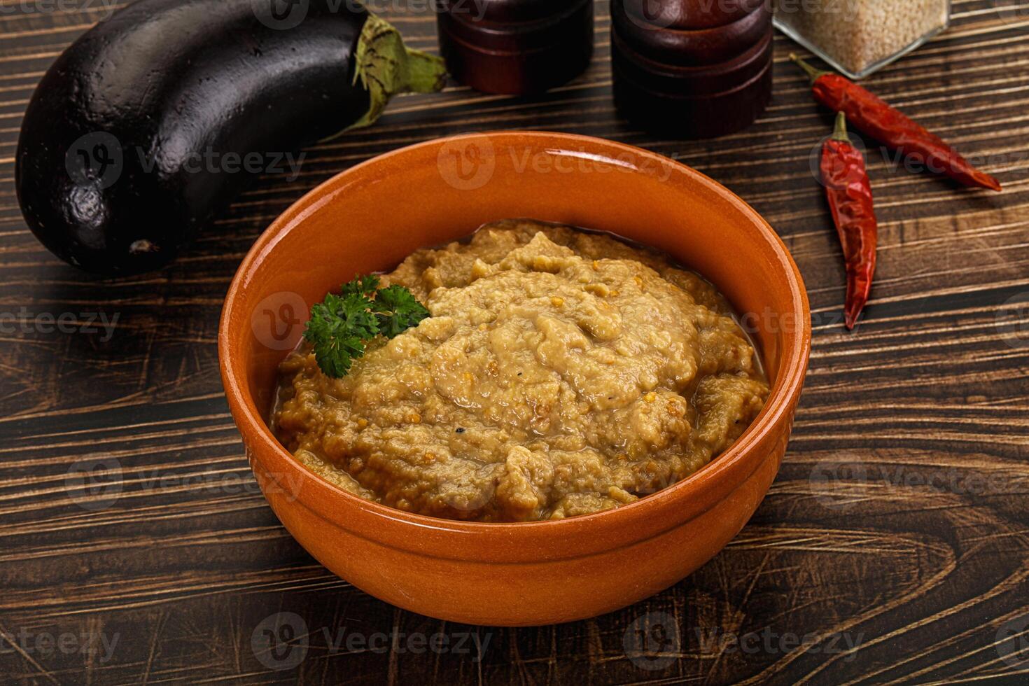 A bowl of food with a spoon and some spices photo