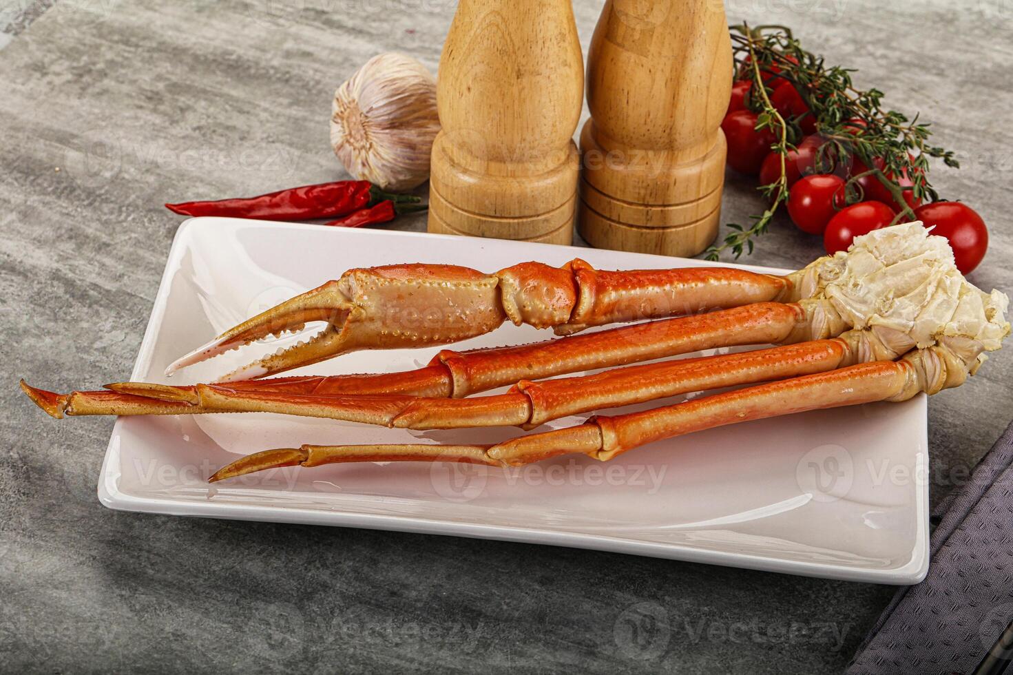 A plate with a crab leg and a pepper photo